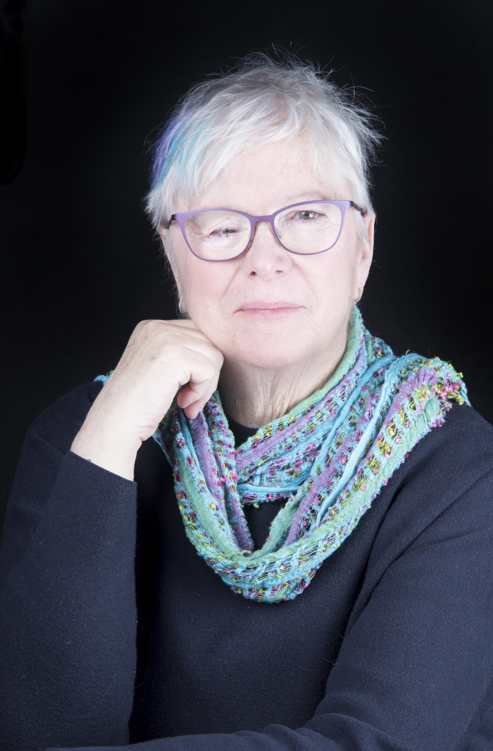 Anne Reid photo of Anne Reid, woman with short grey hair and glasses, with a beautiful blue scarf